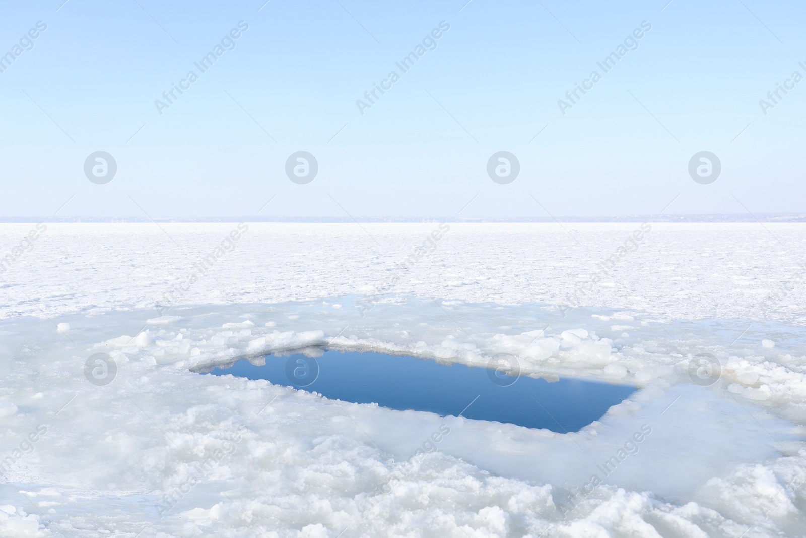 Photo of Ice hole in river on winter day. Baptism ritual