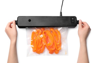 Photo of Woman using sealer for vacuum packing with plastic bagbell pepper on white background, top view