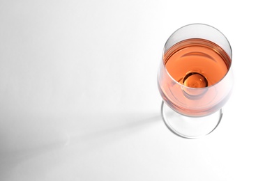 Glass of delicious wine on white background, above view