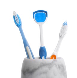 Photo of Holder with tongue cleaner and toothbrushes on white background