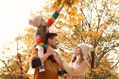 Photo of Happy family with child together in park. Autumn walk