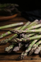 Fresh raw asparagus on wooden table, closeup