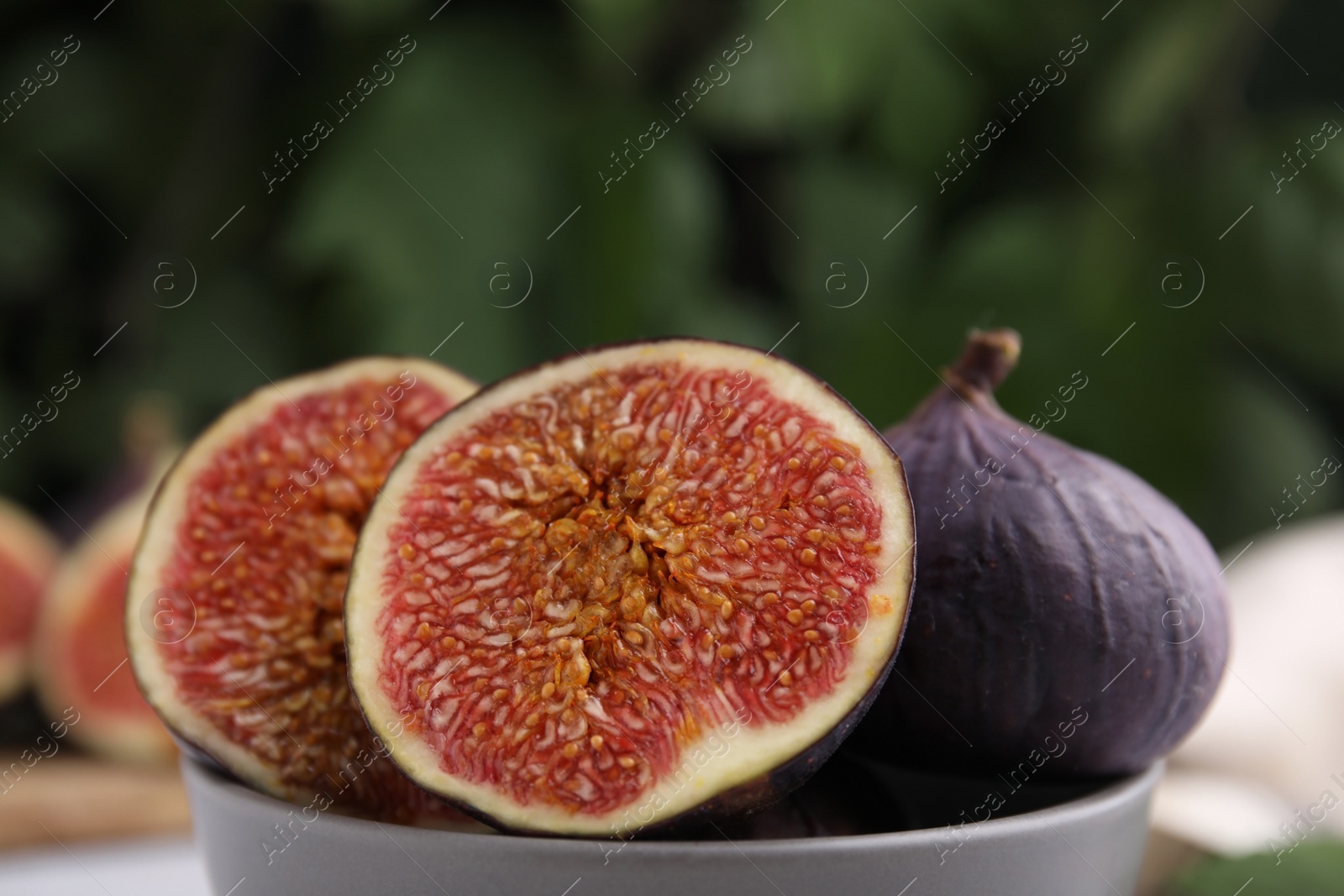 Photo of Tasty ripe figs against blurred background, closeup