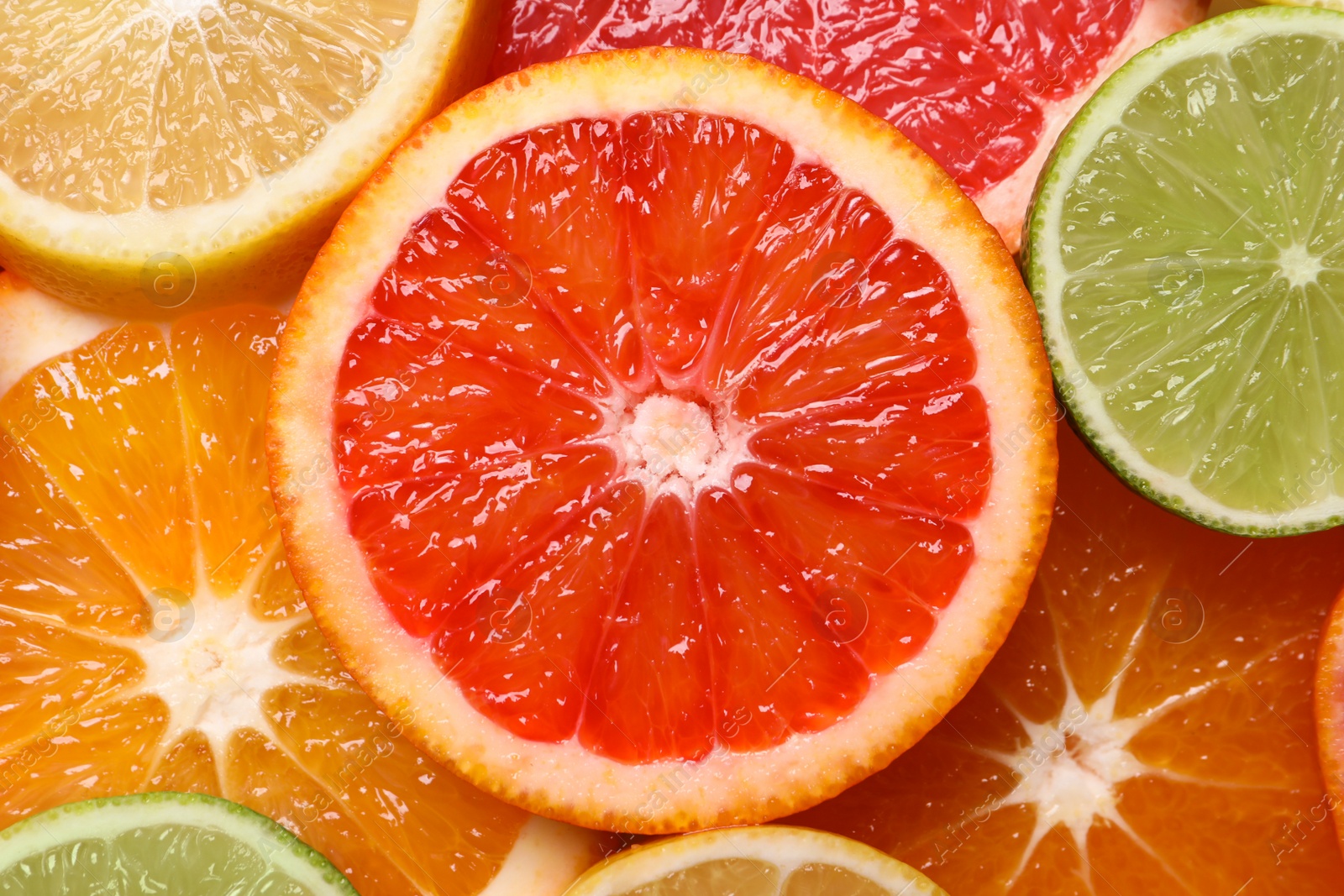 Photo of Fresh juicy citrus fruits as background, top view