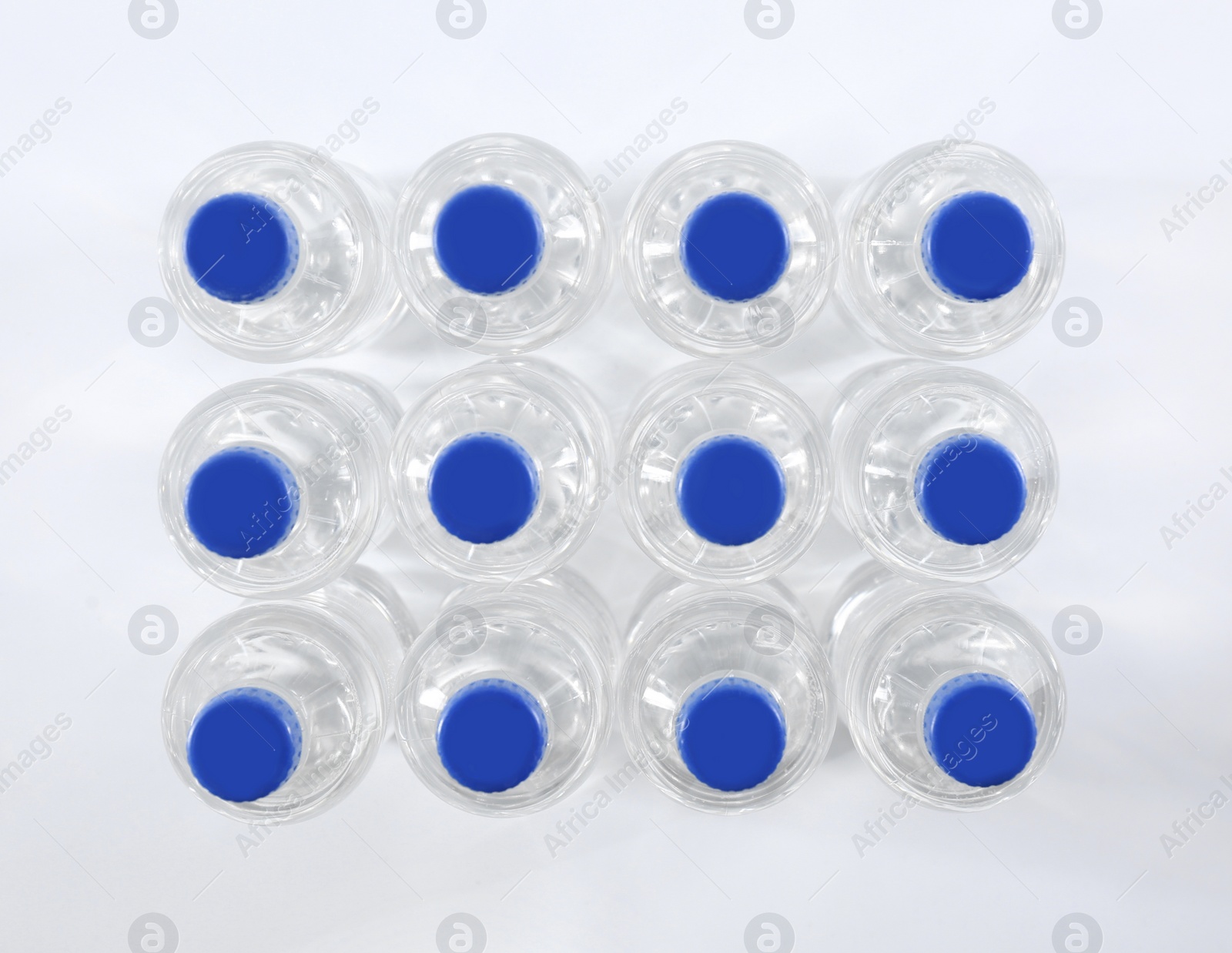 Photo of Plastic bottles with pure water on white background, top view