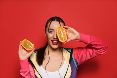 Young woman with fresh kiwano on red background. Exotic fruit