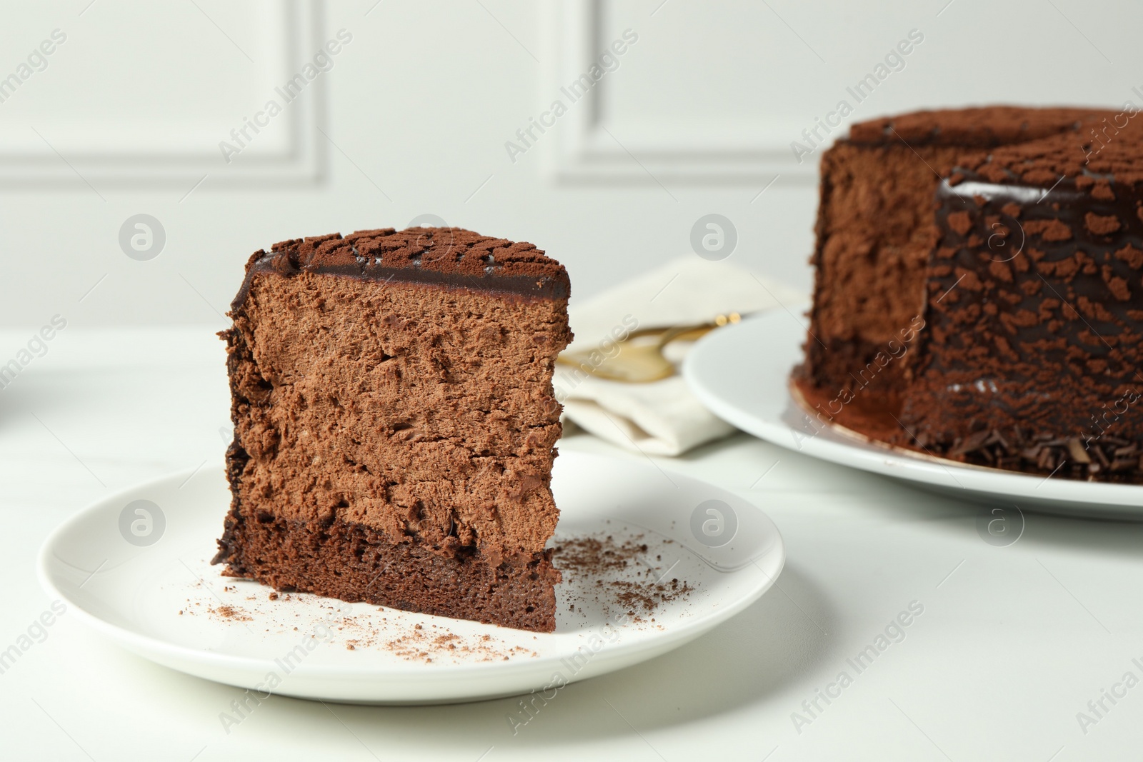 Photo of Piece of delicious chocolate truffle cake on white table