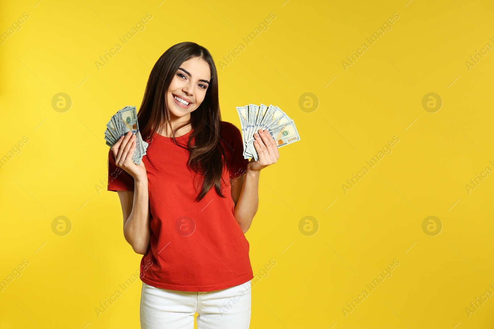 Photo of Young woman with money on color background. Space for text