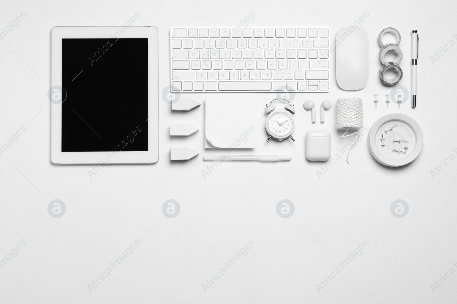 Photo of Flat lay composition with tablet and different office items on white background. Designer's workplace, space for text