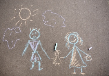 Child's chalk drawing of family on asphalt, top view