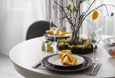 Photo of Beautiful Easter table setting with floral decor indoors