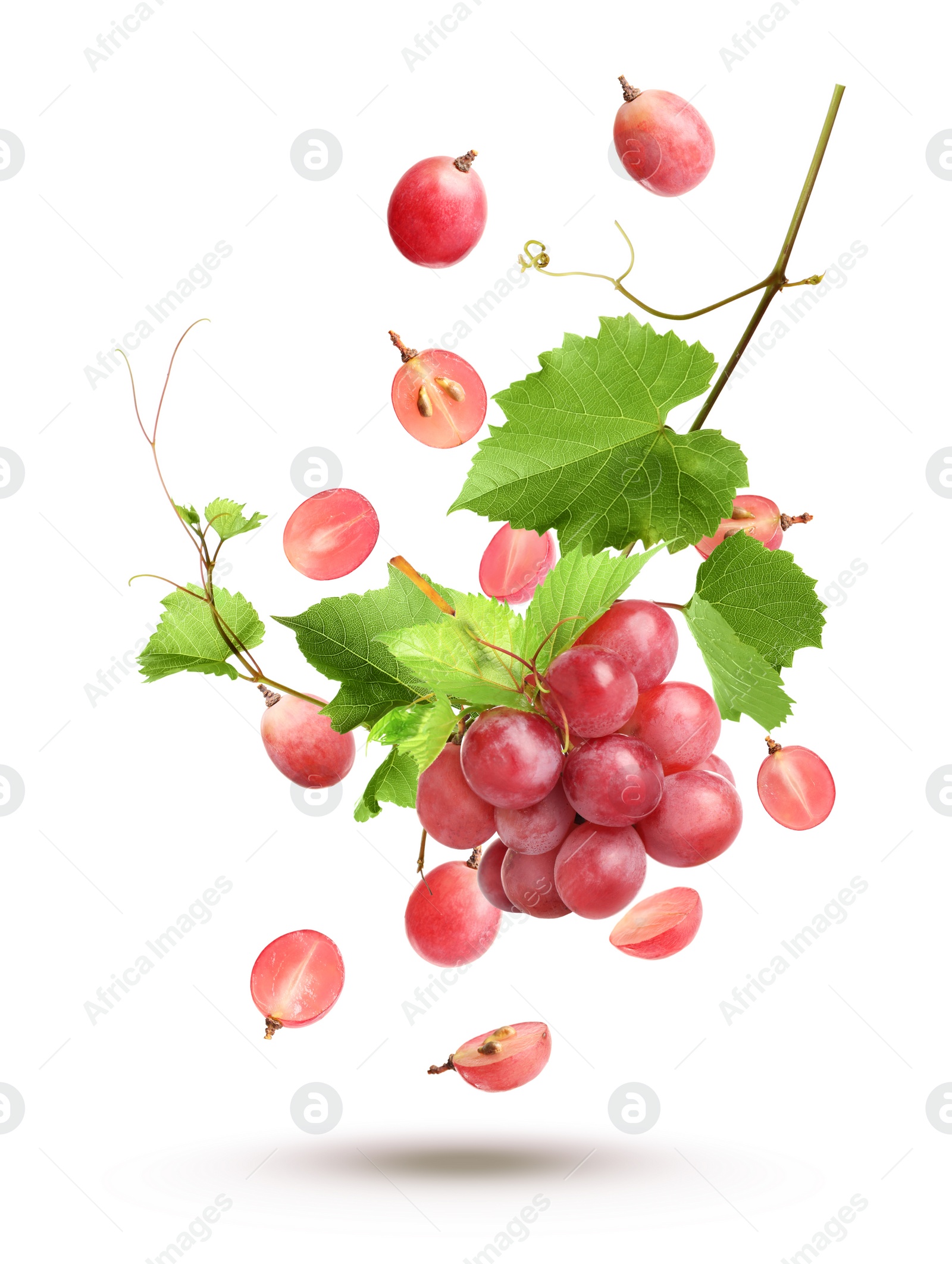 Image of Fresh ripe grapes with green leaves falling on white background