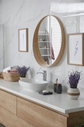 Mirror and counter with vessel sink in stylish bathroom interior. Idea for design