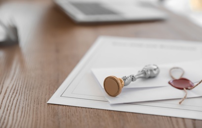 Photo of Vintage notary stamp and documents on desk, closeup