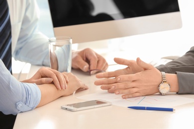 Female manager consulting mature couple in office