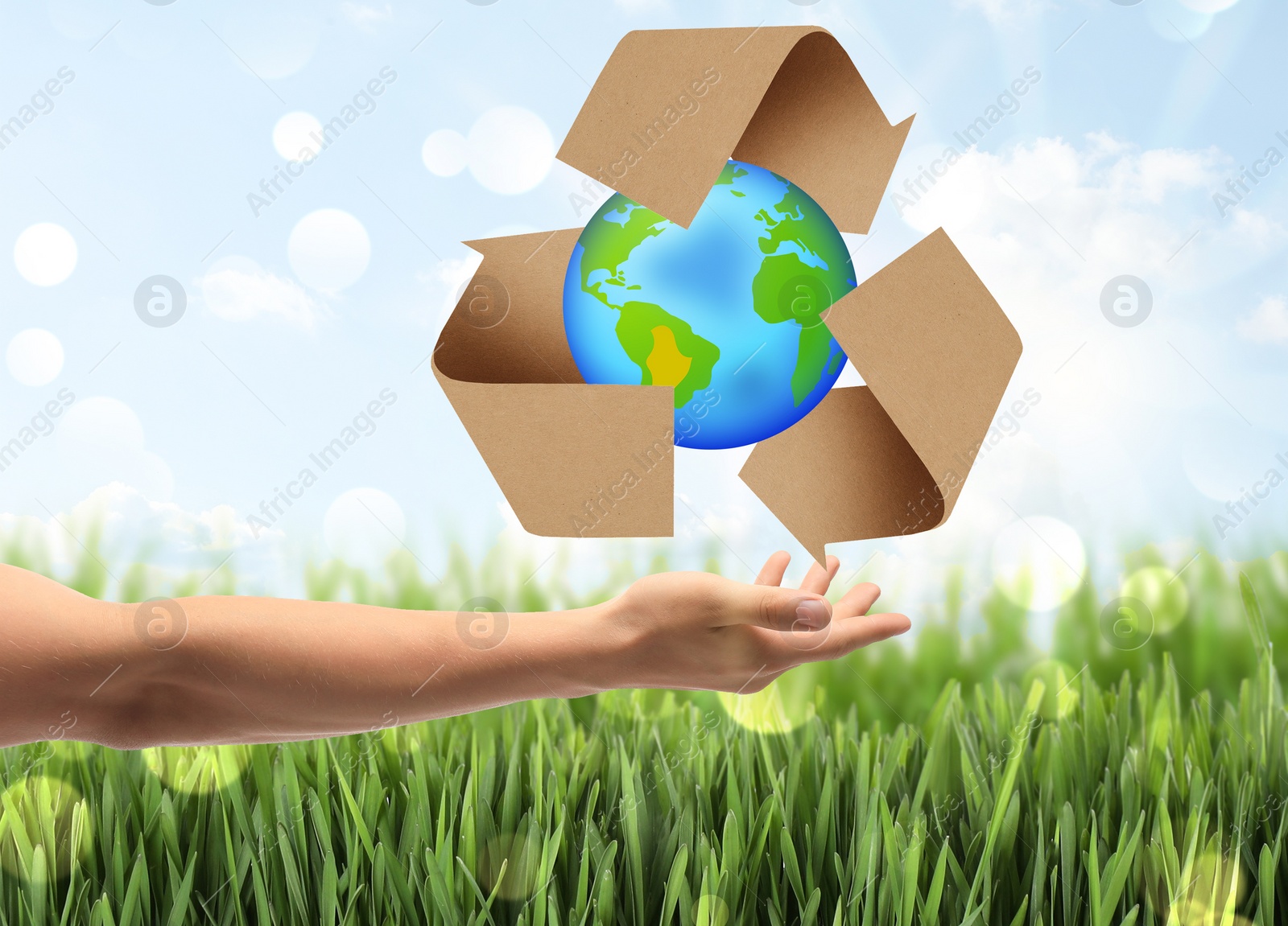 Image of Man with illustration of Earth and recycling symbol in hand, closeup