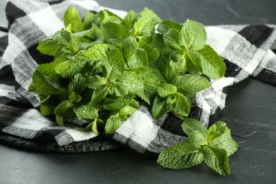 Photo of Fresh green mint leaves on black table