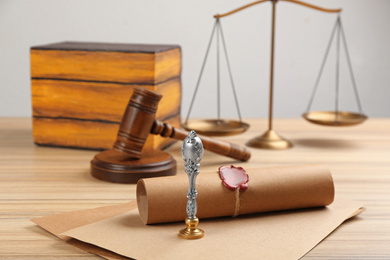 Notary's public pen and sealed document on wooden table