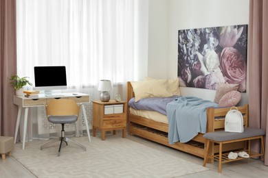 Stylish teenager's room interior with computer and comfortable bed