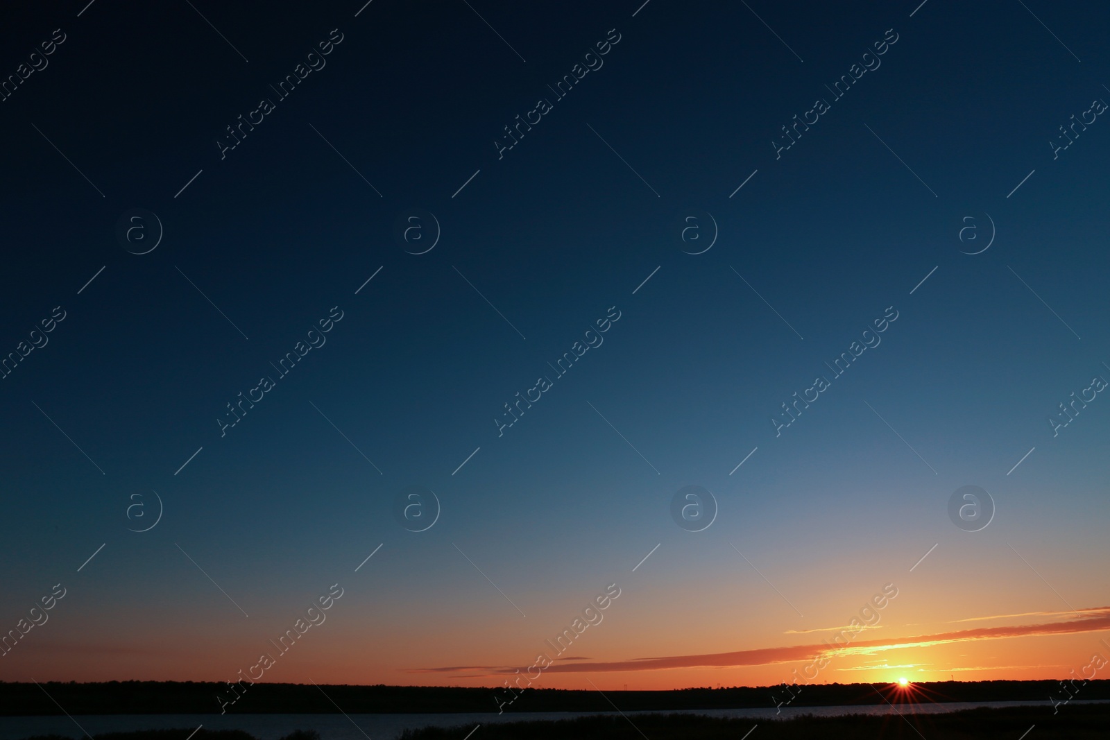 Photo of Picturesque view of beautiful sunrise on riverside. Morning sky