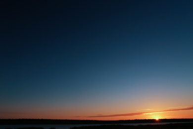 Photo of Picturesque view of beautiful sunrise on riverside. Morning sky