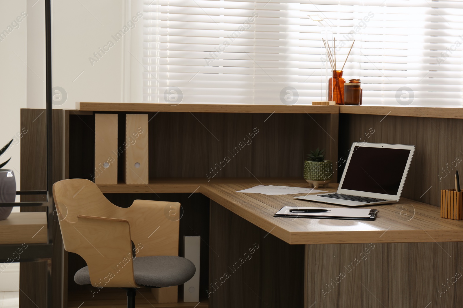 Photo of Receptionist's workplace with laptop in hotel. Interior design