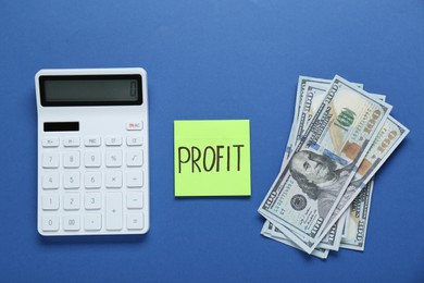 Photo of Sticky note with word Profit, banknotes and calculator on blue background, flat lay