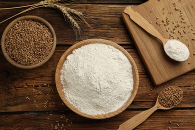 Photo of Flat lay composition with wheat flour on wooden table