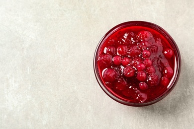 Photo of Cranberry sauce on light table, top view. Space for text