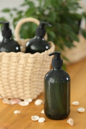 Soap dispensers and wicker basket on wooden table