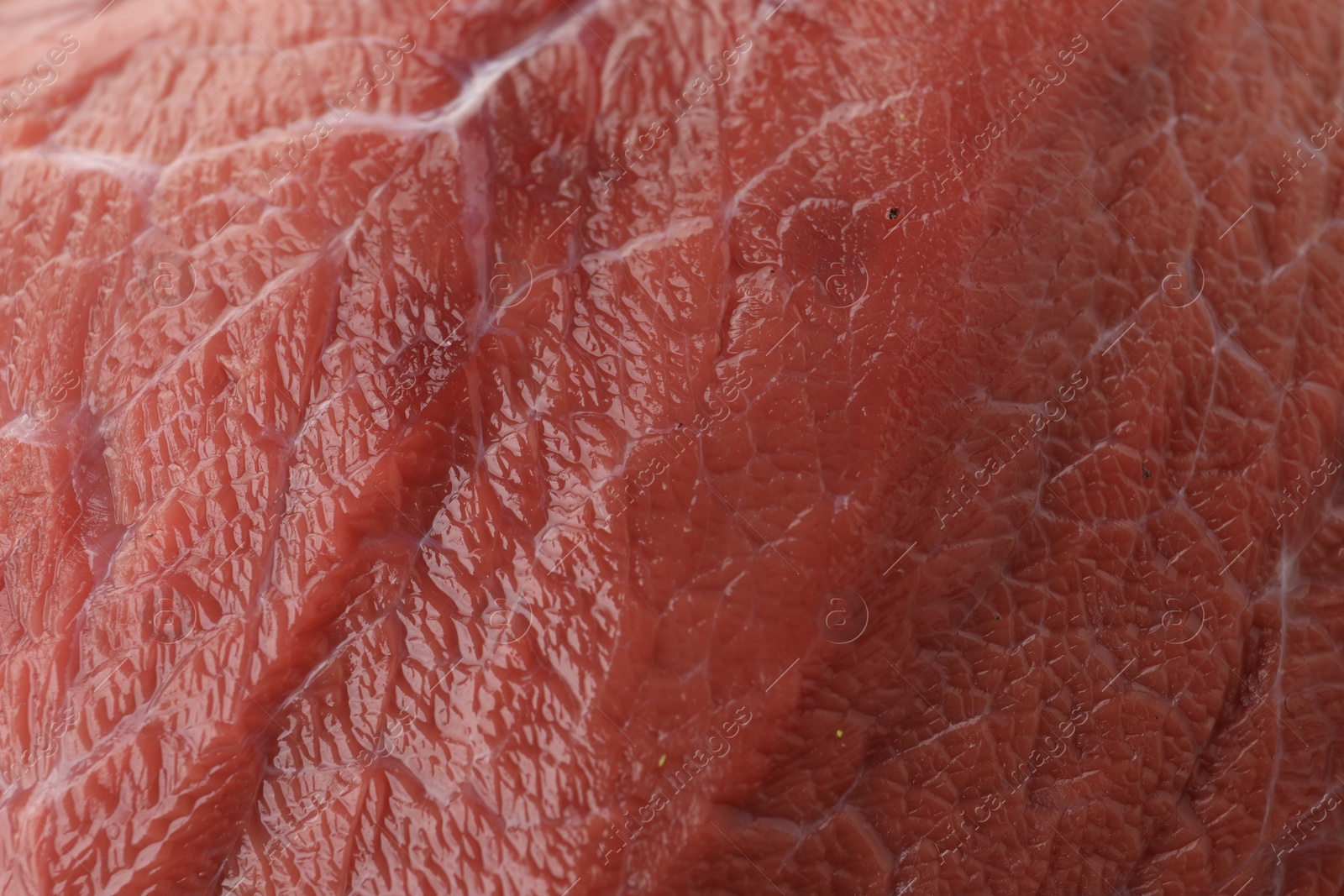 Photo of Piece of raw beef meat as background, closeup