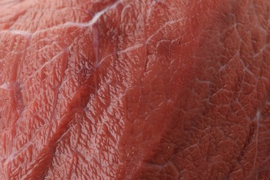 Photo of Piece of raw beef meat as background, closeup