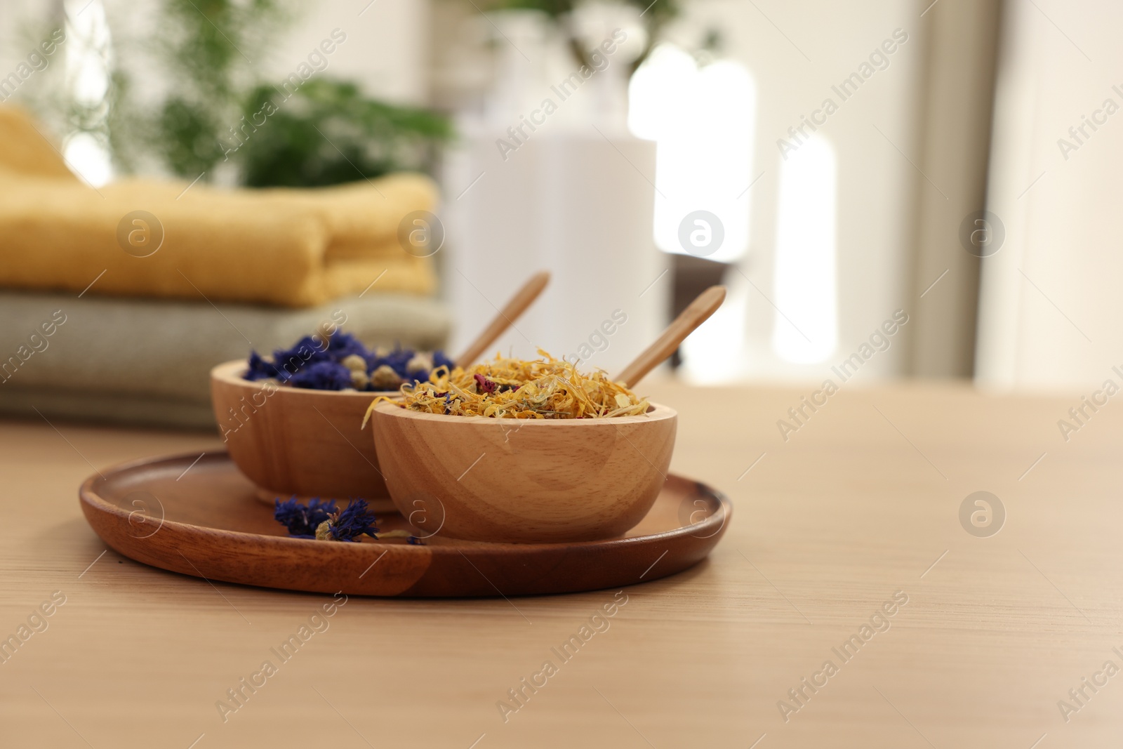 Photo of Dry flowers on wooden table indoors, space for text. Spa time