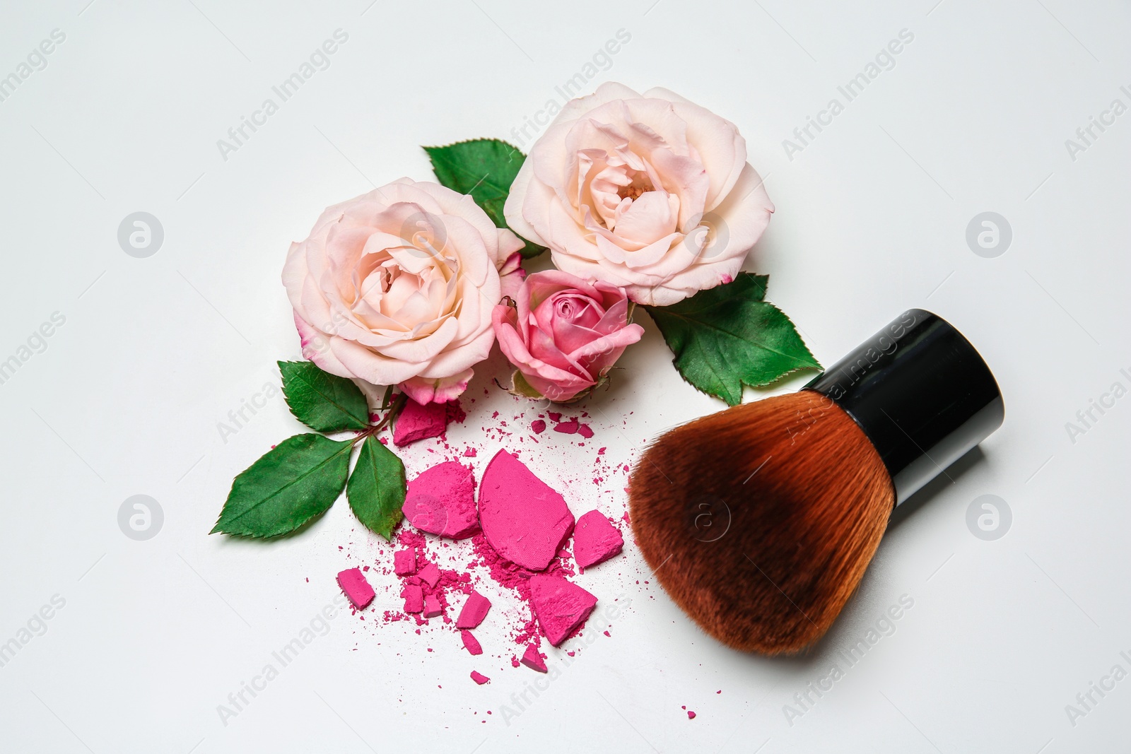 Photo of Composition with makeup brush and flowers on white background