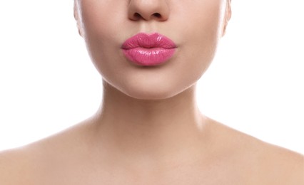 Photo of Closeup view of beautiful woman puckering lips for kiss on white background
