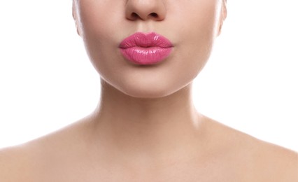 Closeup view of beautiful woman puckering lips for kiss on white background