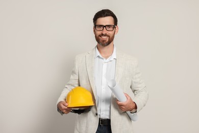 Professional engineer with hard hat and draft on white background