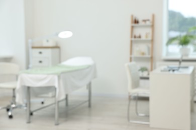 Photo of Modern interior of dermatologist's office with examination table