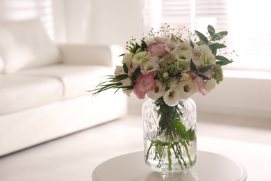 Bouquet of beautiful flowers on table in living room. Interior design