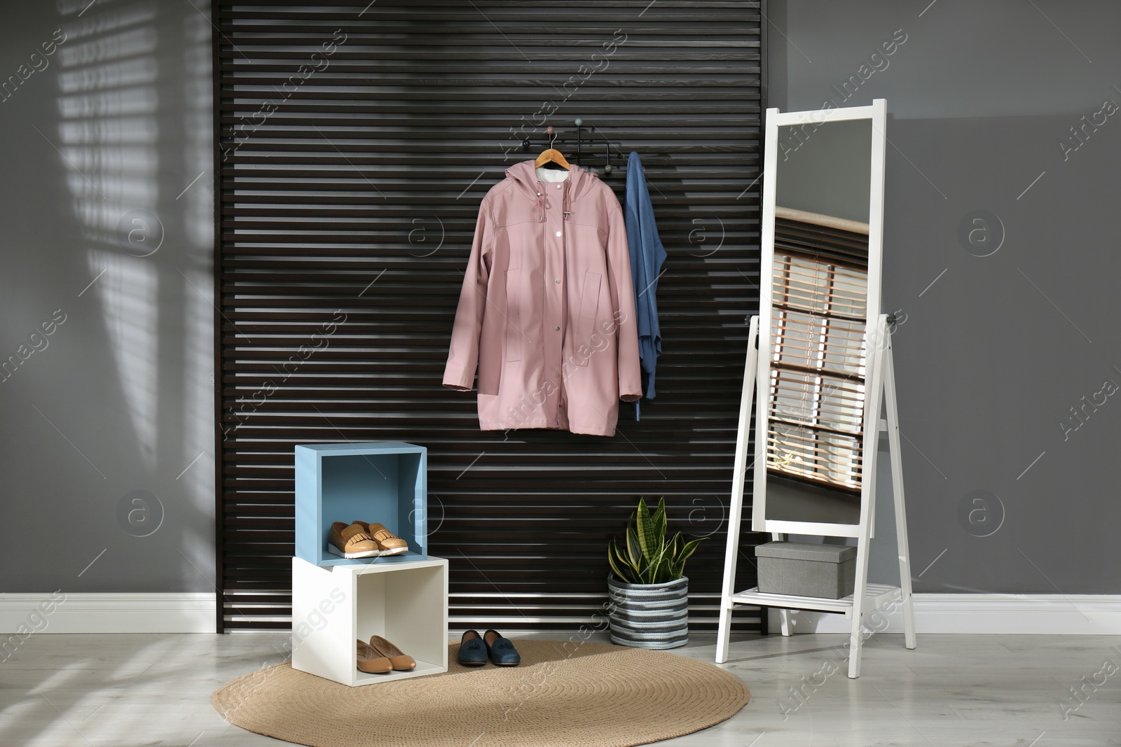 Photo of Hallway interior with stylish furniture, clothes and accessories