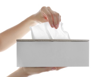 Woman taking paper tissue from holder on white background, closeup