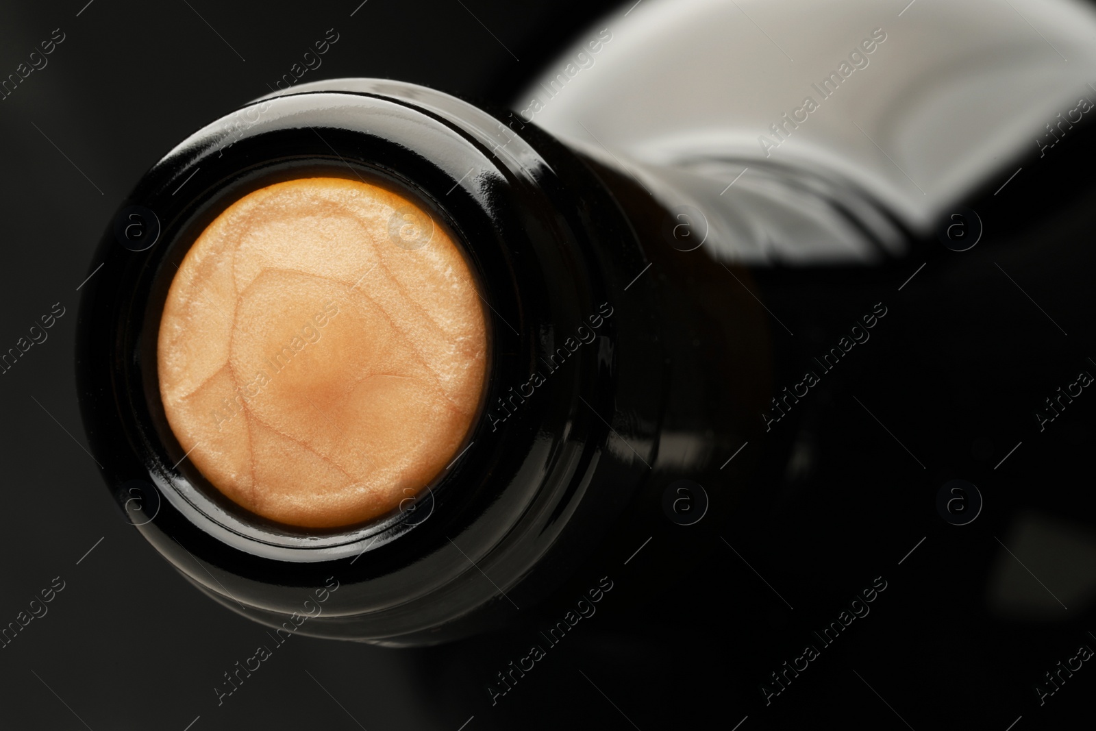 Photo of Closeup view of cork in wine bottle on black background, space for text