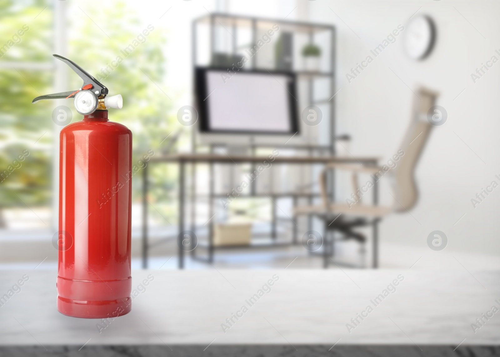 Image of Fire extinguisher on stone table in office. Space for text