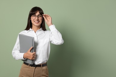 Photo of Happy secretary with folder on light olive background. Space for text