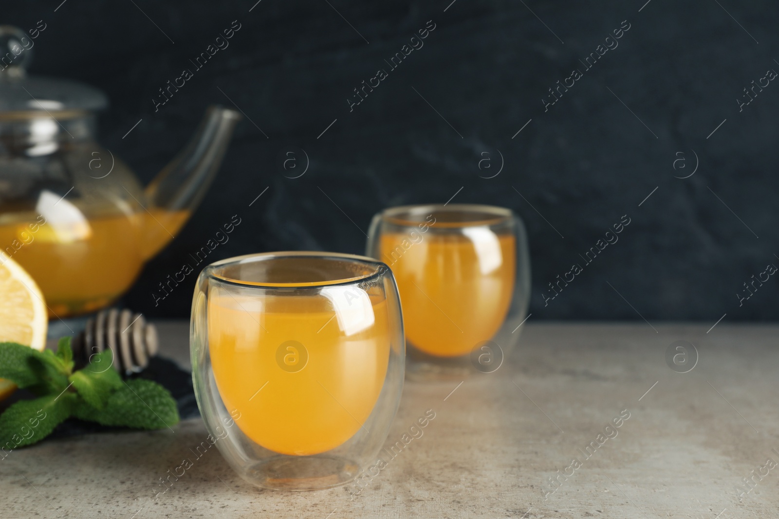 Photo of Immunity boosting drink and ingredients on light grey table, space for text