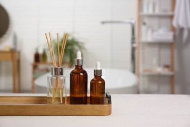 Composition with spa products on white table in bathroom, space for text