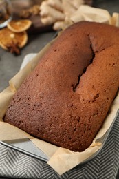 Photo of Delicious gingerbread cake in baking dish on table, closeup