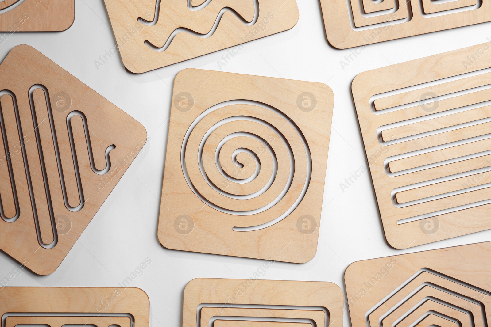 Photo of Wooden finger labyrinths on white background, top view. Montessori toy