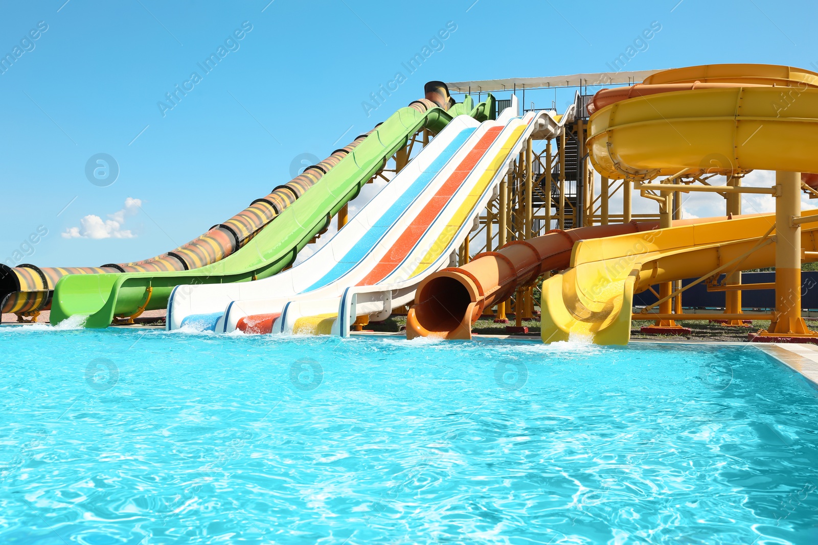 Photo of Different colorful slides in water park on sunny day