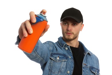 Handsome man holding spray paint against white background